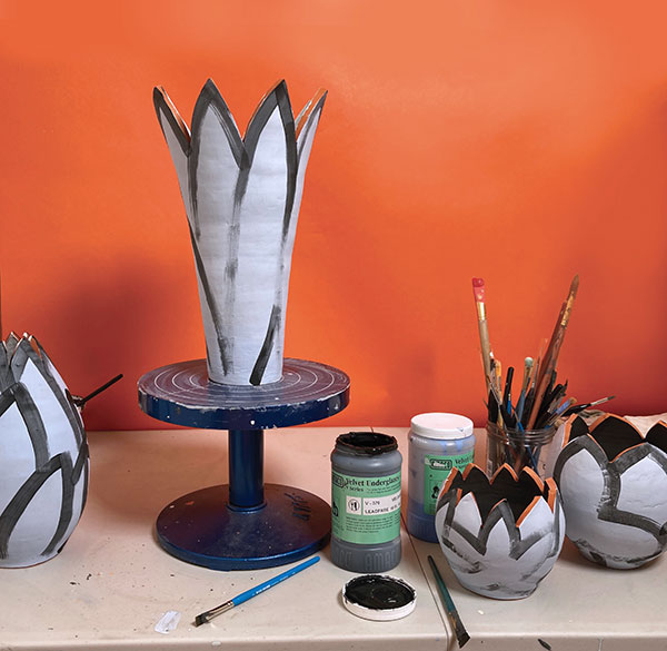 10 Apply quick, bold strokes of black underglaze to lay out the pattern.