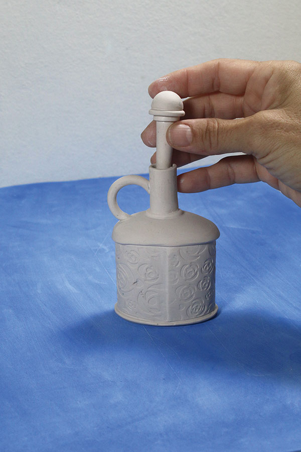 16 Form a rounded knob with a flat bottom, attach the knob to the bottle stopper, and check it for fit.