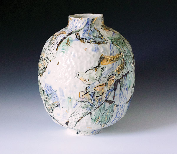 Bird Migration Among Pines Vase, 9½ in. (24 cm) height. Tea set and vase: English porcelain, colored slip, underglaze, glaze, fired to cone 6 in oxidation, gold luster, by Emilie Bouvet-Boisclair. 