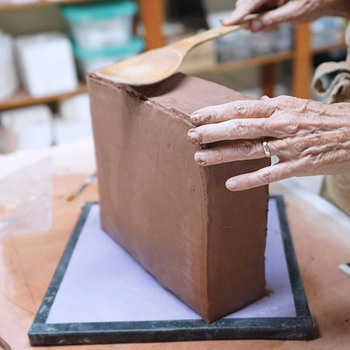 6 Use a wooden spoon to paddle and seal the top of the box. Allow it to firm up.