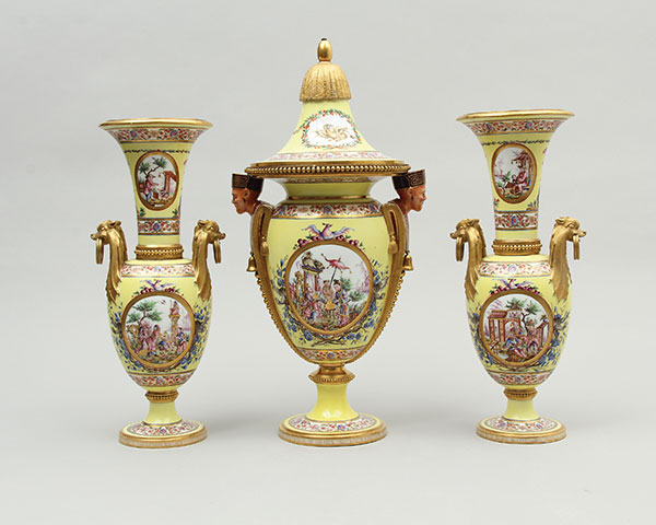 2 Sèvres Porcelain Manufactory, Garniture of Vases, to 17¾ in. (45 cm) in height, porcelain, glaze, lead pigments, matte burnished gold, marble, hand-painted scenes, screen-printed patterns, overglaze enamels, gilding, gilt-bronze mounts, 1780. Gift of George and Helen Gardiner. Courtesy of the Gardiner Museum.
