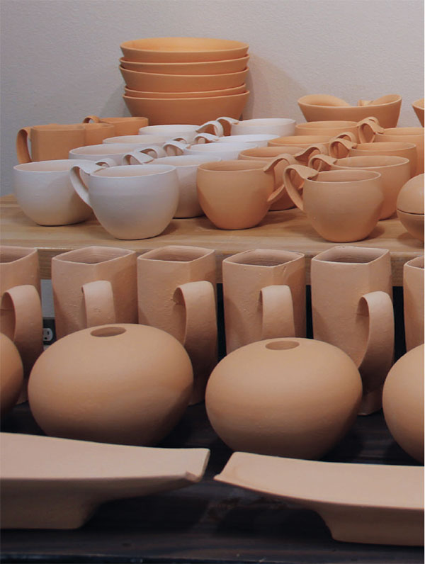 5 Bisque-fired work is laid out and decisions are made on which pieces will make it into the firing and how they will be paired with one another.