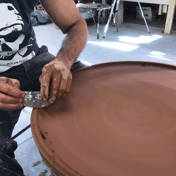 7 In preparation for joining the plate and freshly thrown ring, score the rim of the plate using a serrated rib and add water.