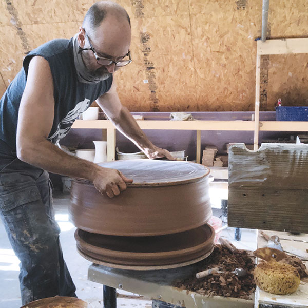 8 Flip the freshly thrown ring onto the leather-hard plate and join the two rims. Remove the bat from the ring using a cut-off wire.