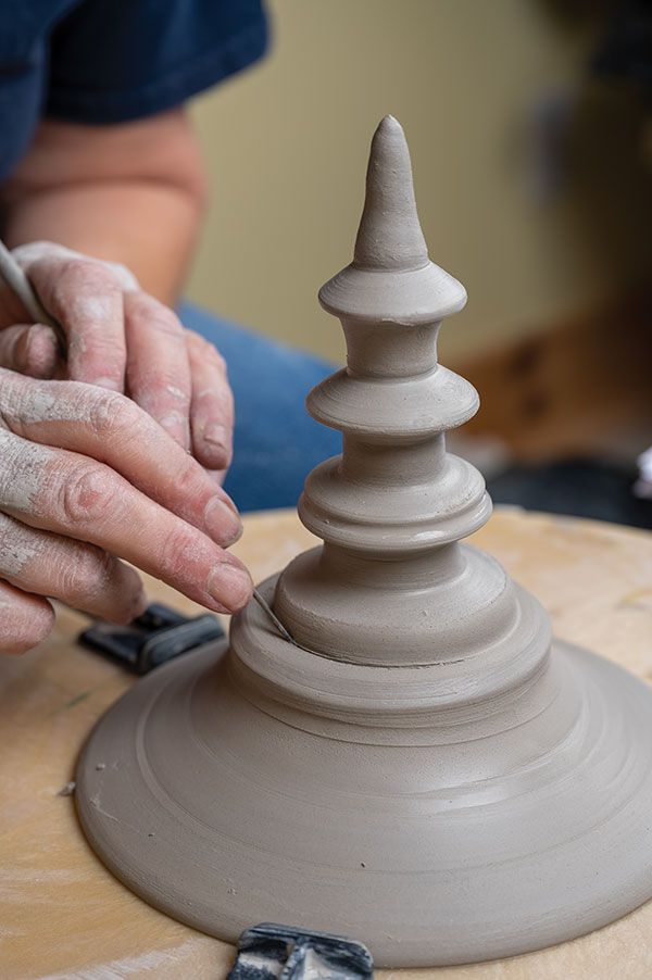 18 Hollow out the finial, then score, slip, and attach it to the lid. Trim the join until it looks like one piece. Refine the lid curve.