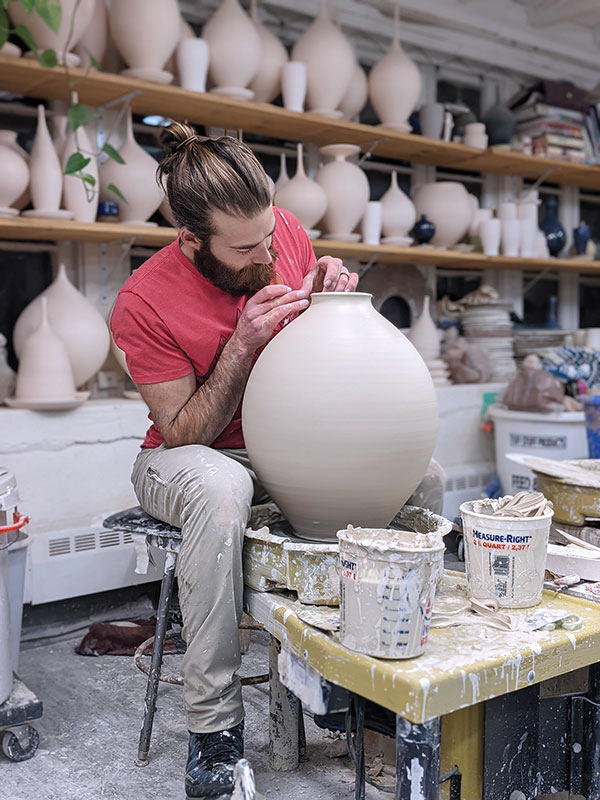 4 Drew Darley throwing a large porcelain vase.