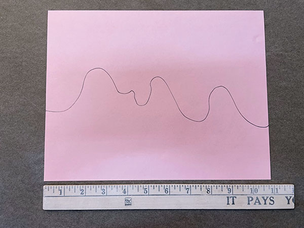 1 On a piece of paper, along the 11-inch side, draw a profile of the mountains.