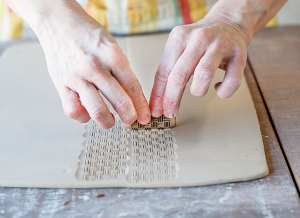 1 Roll out 5 slabs, then use a stamp to add texture down the center of the body slab.