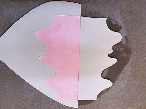 2 Cut the paper along the curves, then cut out the shape on a ¼-inch thick clay slab.