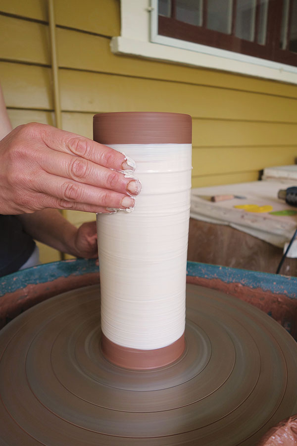5 Apply slip with your fingers or a wide brush. The slip should be stiff enough not to run down the side of the pot.