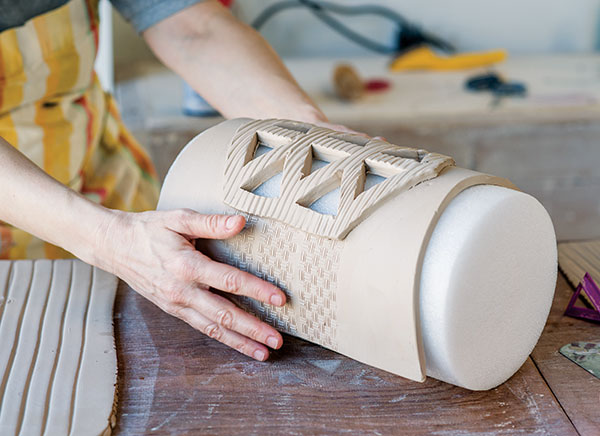 9 Lay the soft slab on a cylinder (foam roller here) to create a rounded shape.