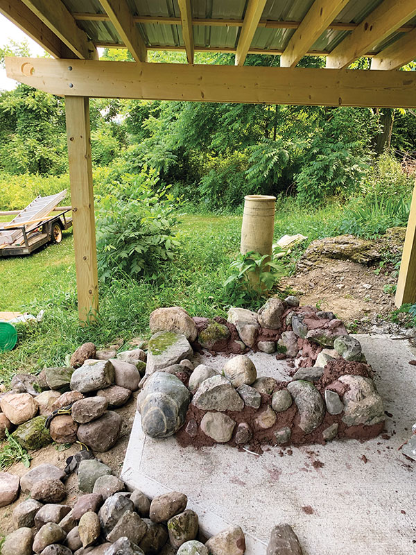 2. Stack cobblestones in layers with mortar mixture troweled between the stones.