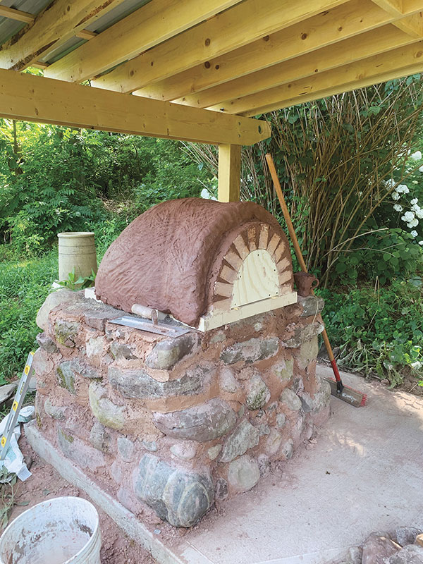 12. First layer of clay/sand mix on the dome, ready for the outer layer of insulating mix.