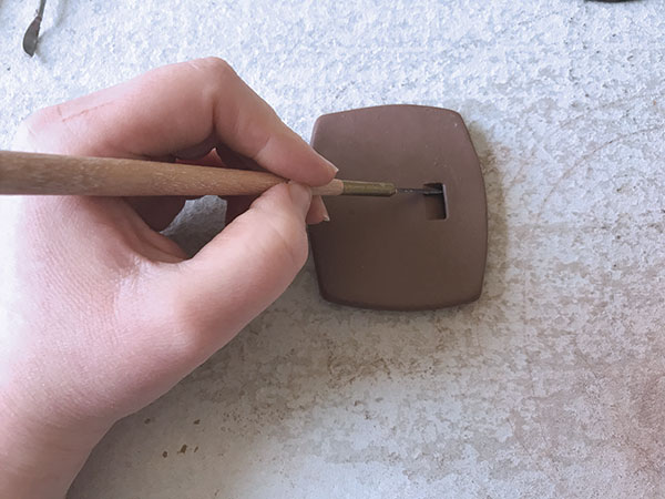 7 Create a notch by carving out a small area of clay at an angle. Use carving tools, then a rubber-tipped tool to compress.