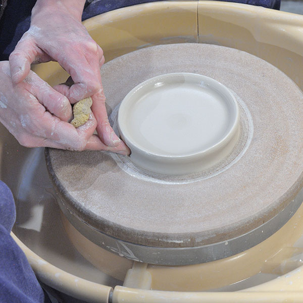 1 Push the base inward, creating a raised ridge that will become the lip of the plate.