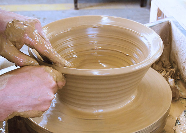 2 Define the rim early in the throwing process. Keep the rim thick to allow for widening the diameter.