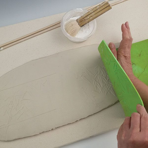 2 Press the textured mat onto the slab, using the palm of your hand.