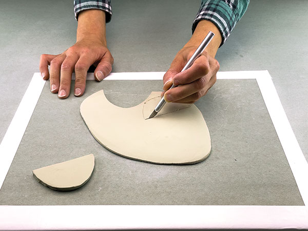 4 Cut identical half-moon-shaped handles from a ¼-inch-thick slab of clay.