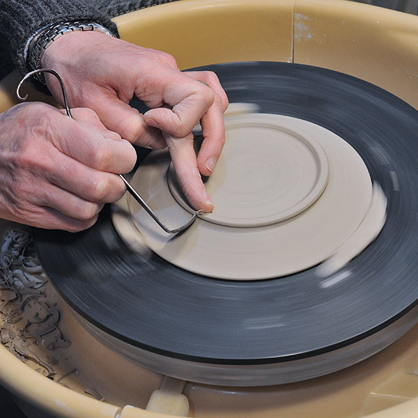 4 Trim the base and define the foot ring when the plate is leather hard.