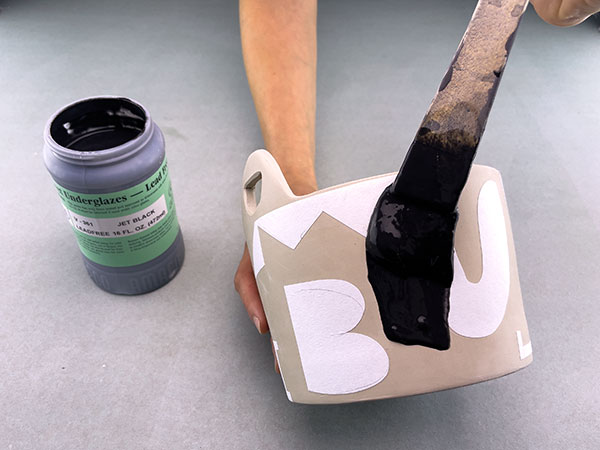 10 Use a hake brush to apply two coats of Amaco Jet Black underglaze to the entire exterior of the piece.