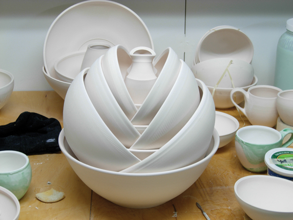 9 An arrangement of bisque-fired, wheel-thrown bowls and a vase in Tonsgard’s studio.