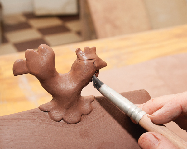 12 Continue smoothing and sculpting. Poke a hole in the hollow knob for air to escape during drying and firing.