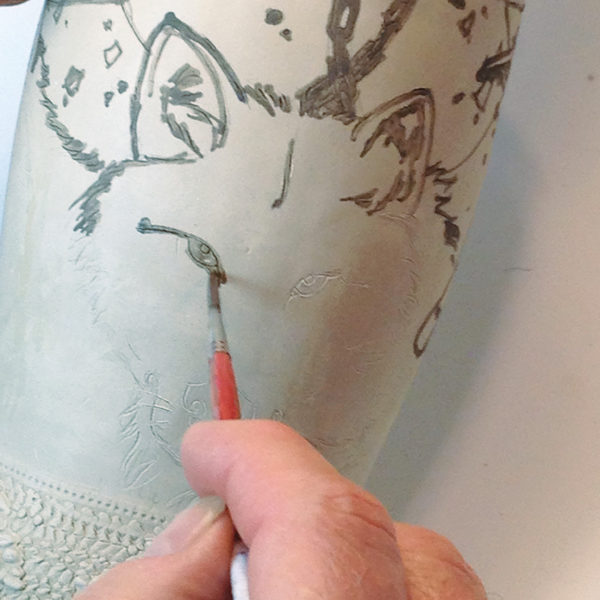 2 Lay black slip into the incised lines using a small, thin-tipped brush.