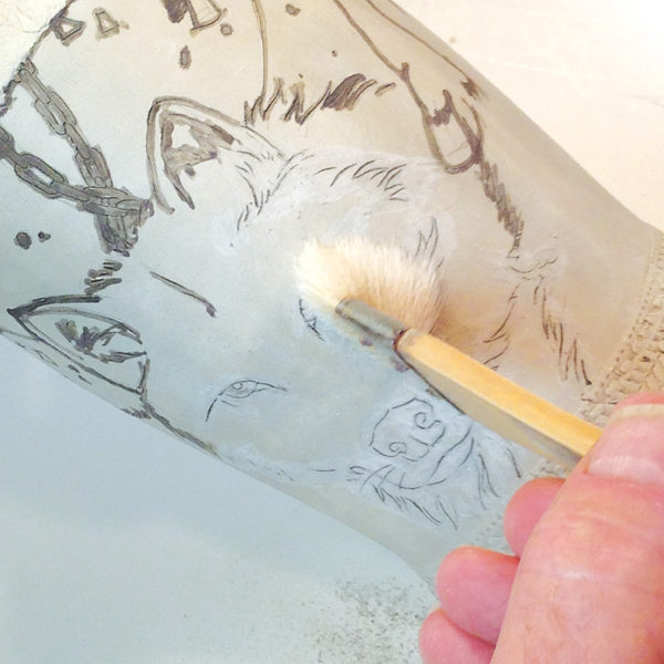 4 Carefully brush excess slip off of the surface using a soft-bristled brush.