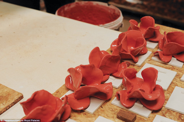 6 A bright red glaze was applied to the bisque-fired poppies before they were returned to the kiln for the second and final firing.