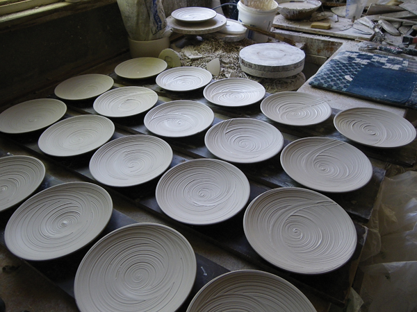 2 Jigger/jollied and Hakeme slip-decorated porcelain side plates, drying on ware boards in the studio, 2013.