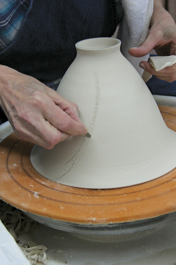 1 Mark and score lines on the trimmed and still leatherhard bowl where altering will take place.