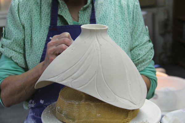 11 Carve the surface, following the drawn lines. Vary the carving tools used depending on the drying stage of the clay. Tools should range from blunt tools for softer clay to very sharp-edged tools for bone dry clay.