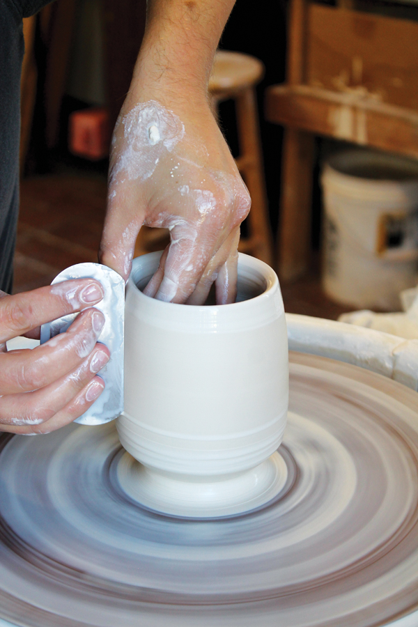 1 Throw a 1¾-pound ball of clay into a cup shape, then refine it with a flexible steel rib to remove the throwing lines.
