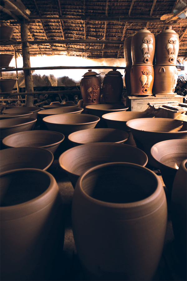 6 Unsold, large terra-cotta jars sit in a storage hut.