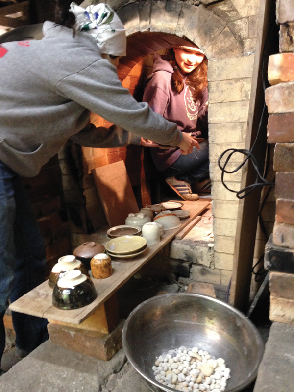 3 Students unloading pots from the university’s Noborigama wood kiln.