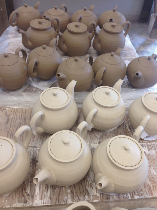 9 Greenware teapots awaiting bisque firing.