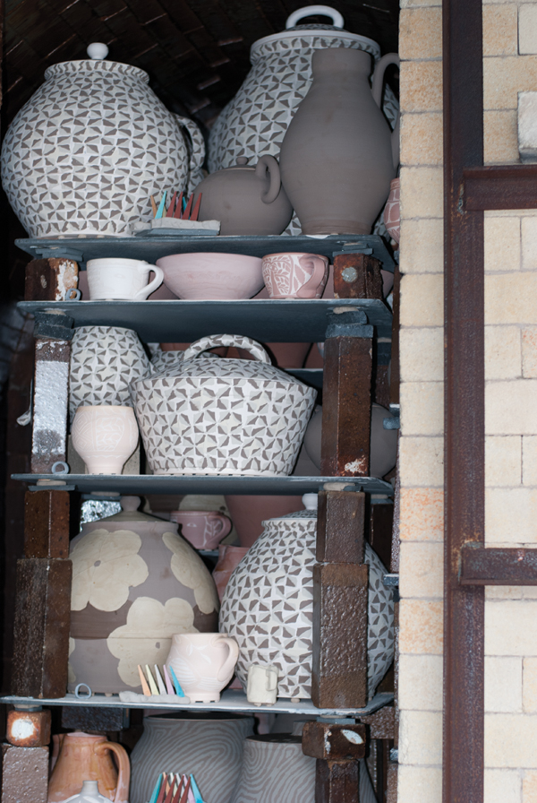 11 Glazed pots stacked in the kiln, ready for firing.