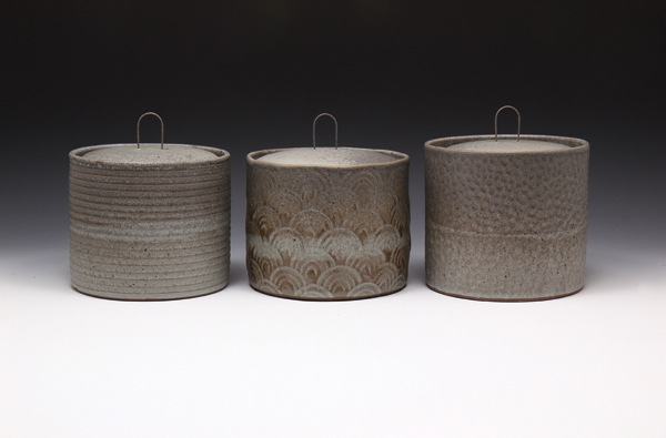 2 Textured jars with wire handles, to 5.5 in. (14 cm) in height.