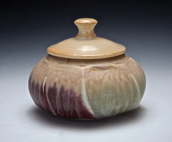 The finished, flange-lidded jar, with ash glaze layered over other glazes and fired to cone 10.
