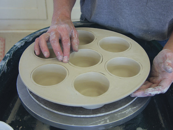 6 Flip the muffin pan over and carefully blend the edge of each cup into the top of the slab.