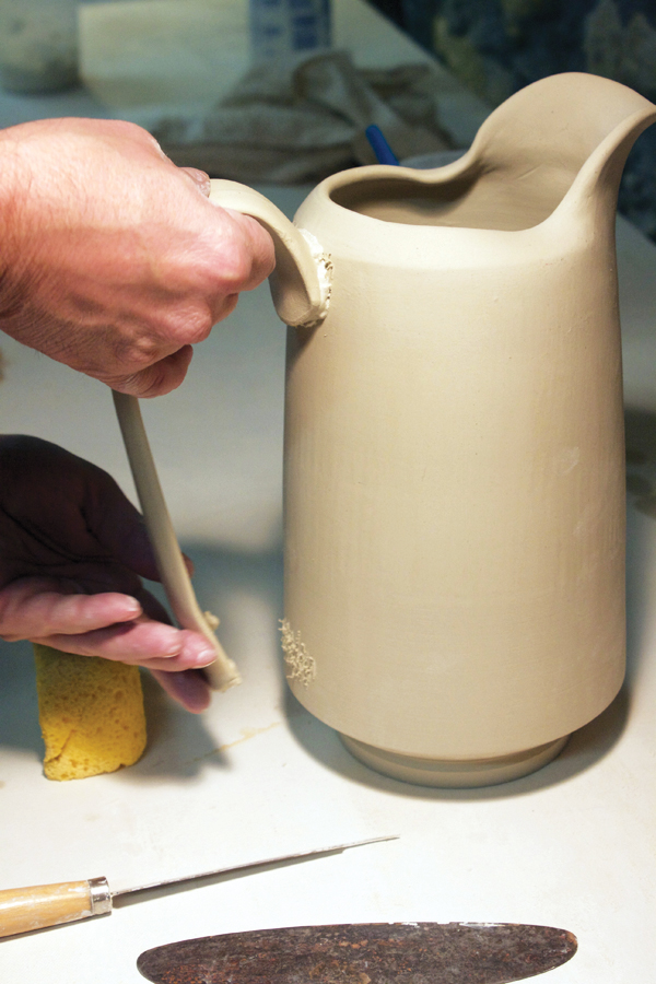 5 Attach a firm, but still flexible handle to the pitcher.  The handle is pulled and allowed to set up before the pitcher is thrown.