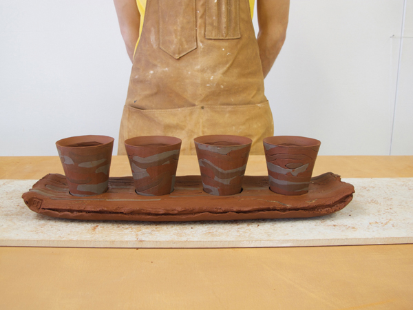 Place the cups in the tray and make any final adjustments before letting the entire piece dry together.