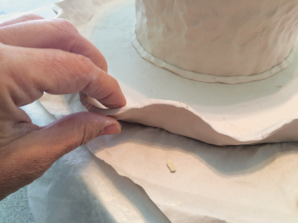 9. Pinch the cut edge to soften and finish the look of the rim.