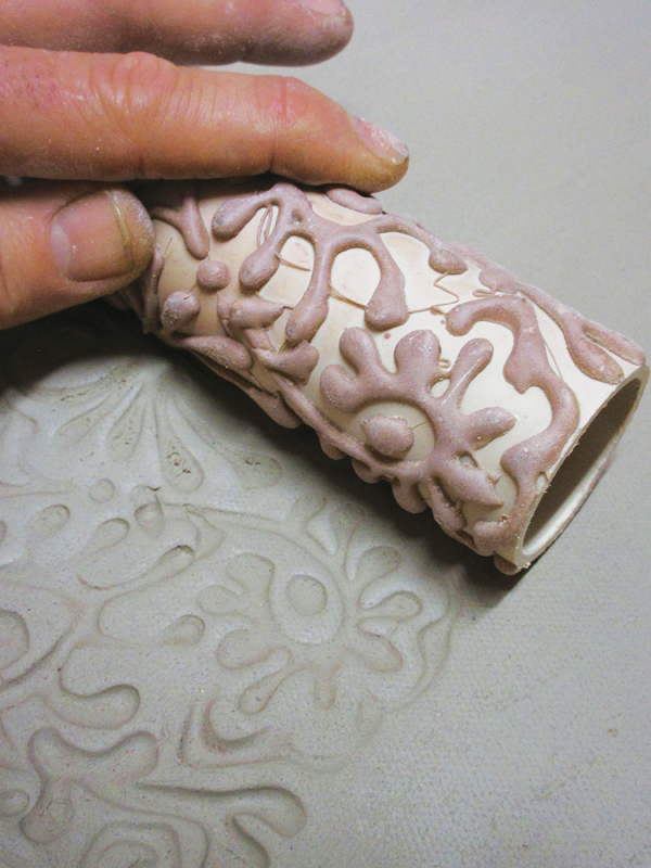 6 Create a textured rolling pin by drawing patterns with hot glue onto a PVC tube and use it to pattern the slab.