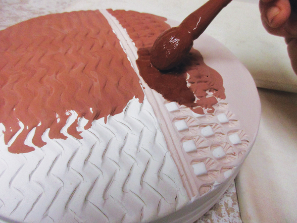 12 Fill the stamped and textured areas with one or more breaking glazes, using a brush for more control.