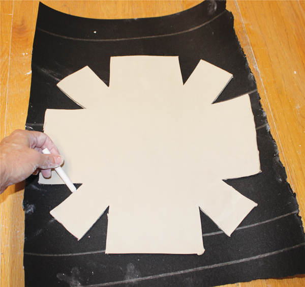 4 Lay the cut slab on tarpaper, then trace around it to make a template.