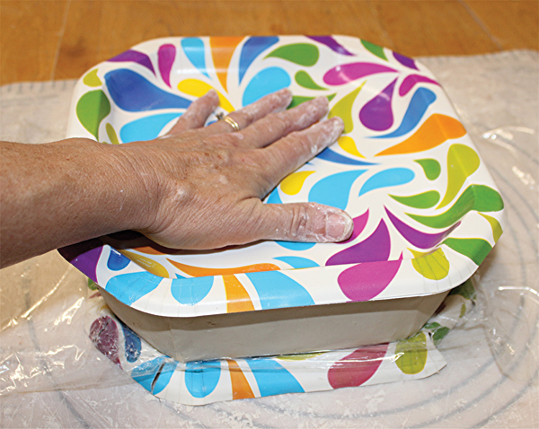 7 Fit another paper plate over the top to make sure the form is straight.