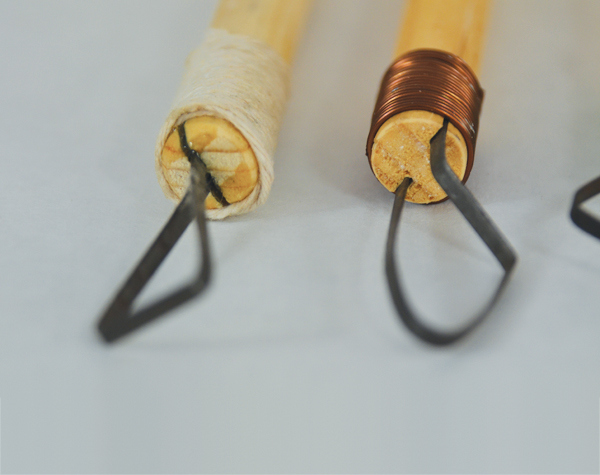 Detail of different loop carving tools fitted and glued into drilled holes and cut slots.
