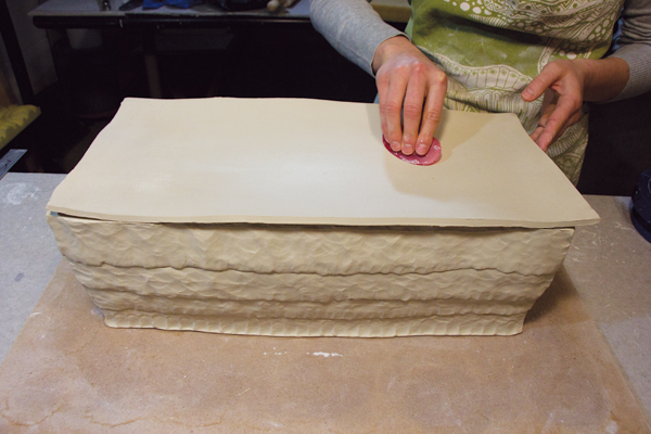 11 Drape a slab over the lid walls, slump it slightly with a rib, and leave it until it’s leather hard. Flip the slab over, trim, then attach.