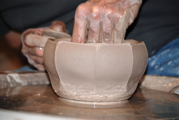 3 After cutting the straight facets, use your inside hand to flare out the wall to the desired bowl shape. Try not to touch the outside.